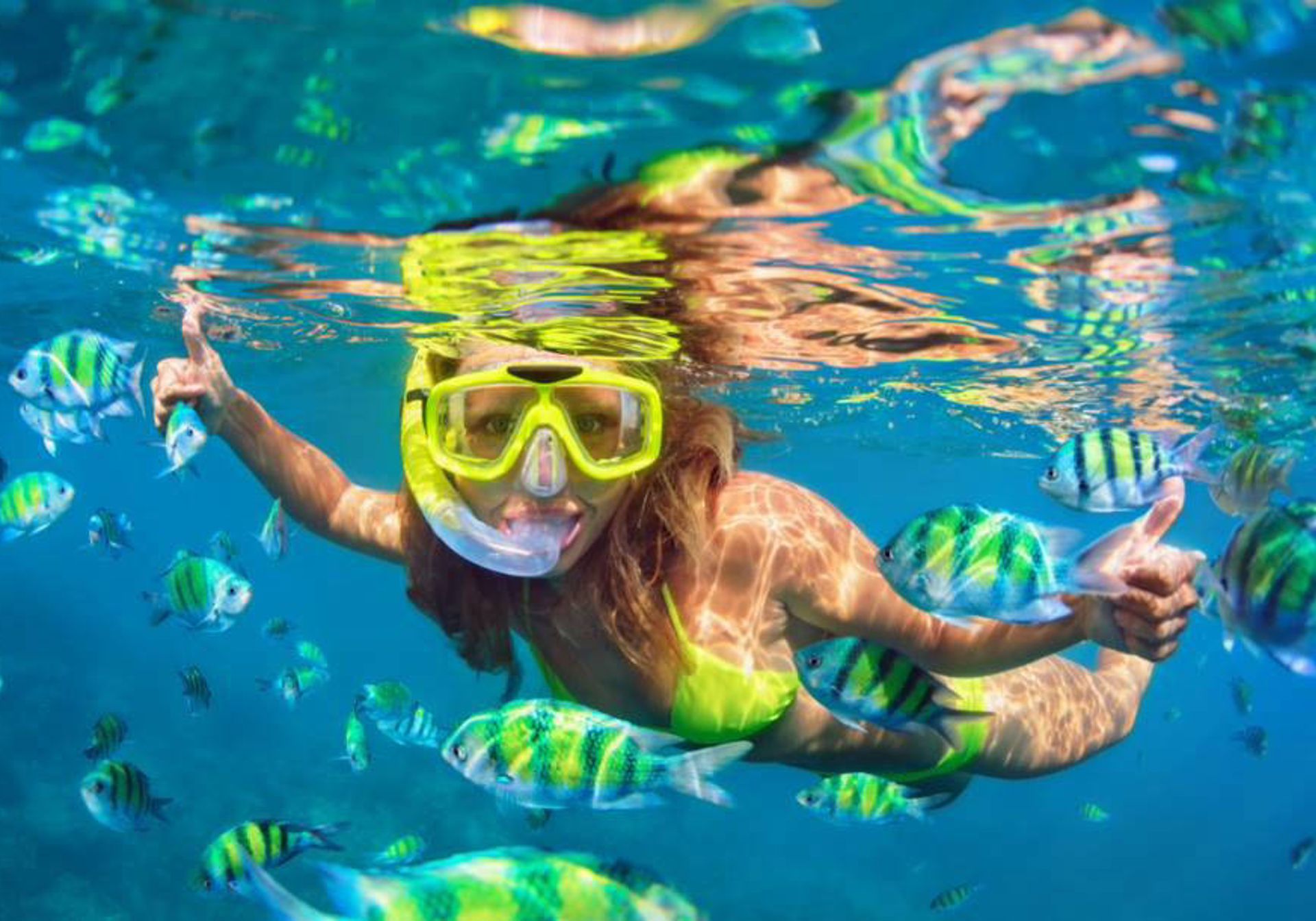 Woman snorkling with fish