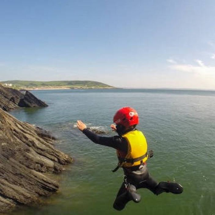 A boy jumping off a cliff