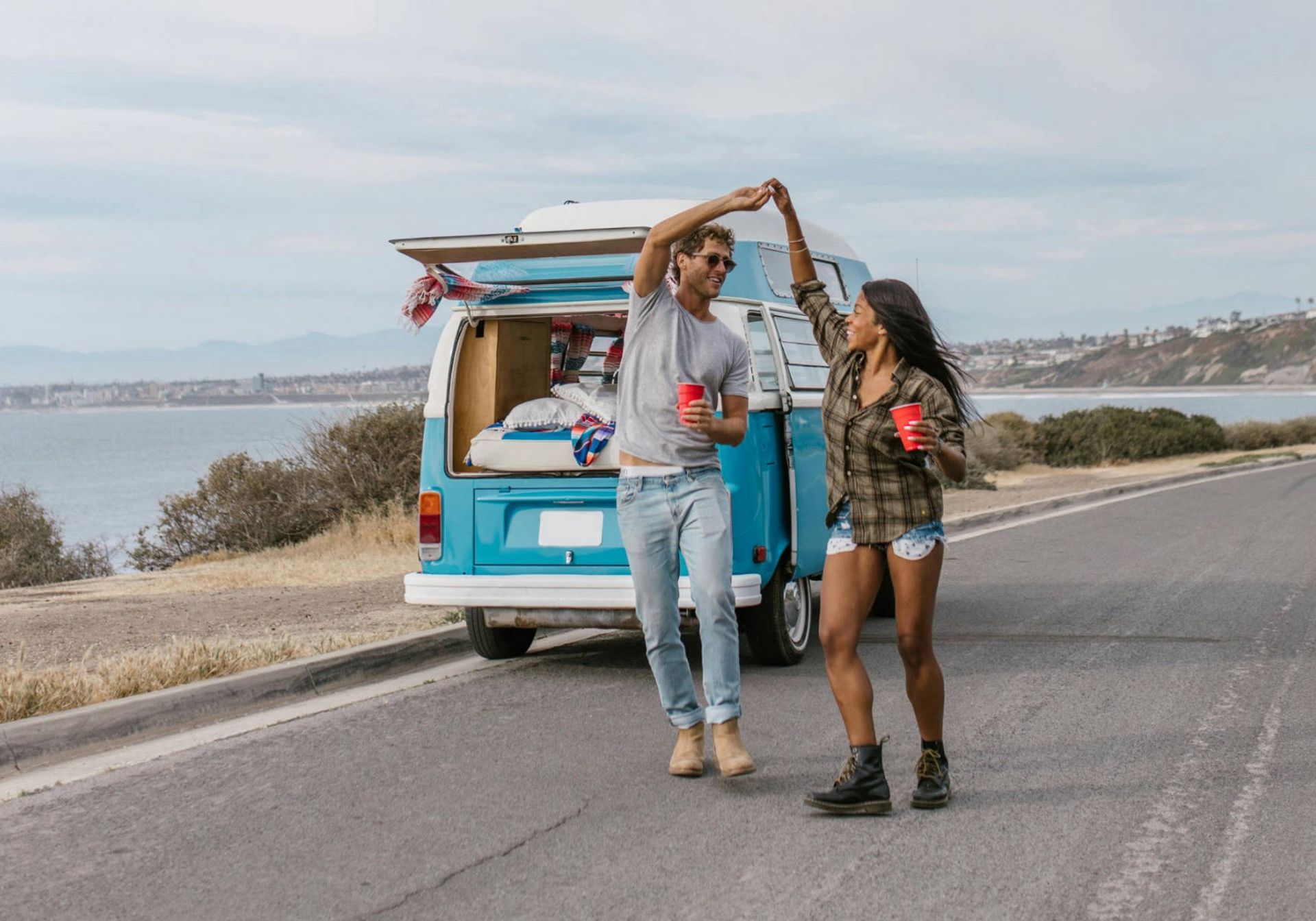 Couple dancing outside a camper van