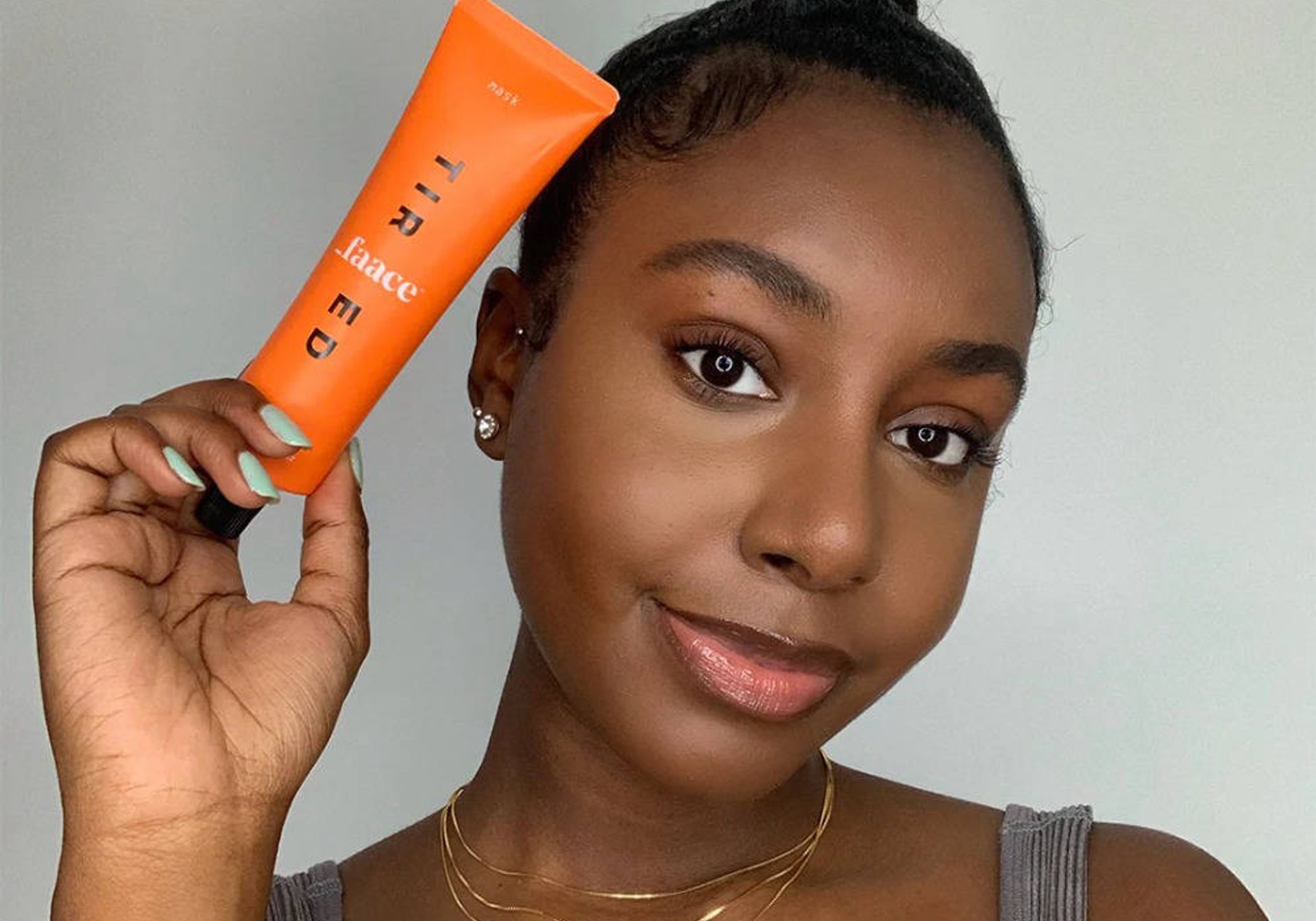 woman holding a sweaty faace mask