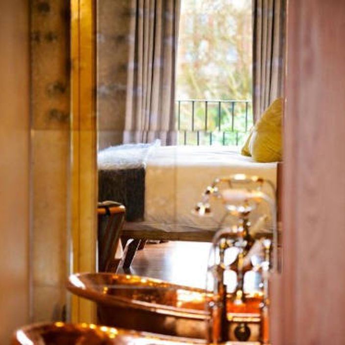 a bath tub and a bed in a hotel room in the riverhouse richmond