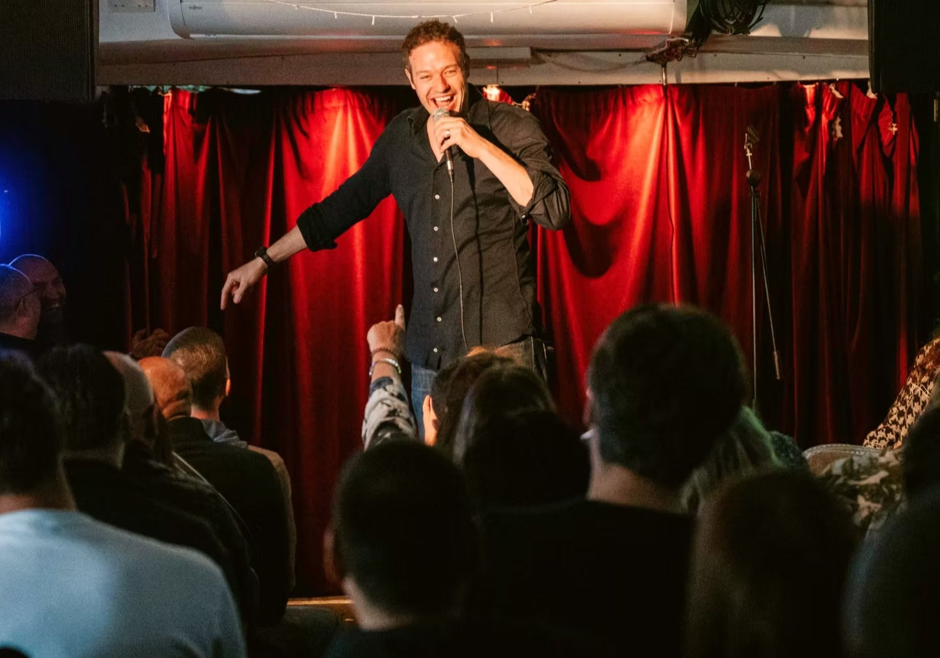 red curtains with spotlight. Silhouette of heads