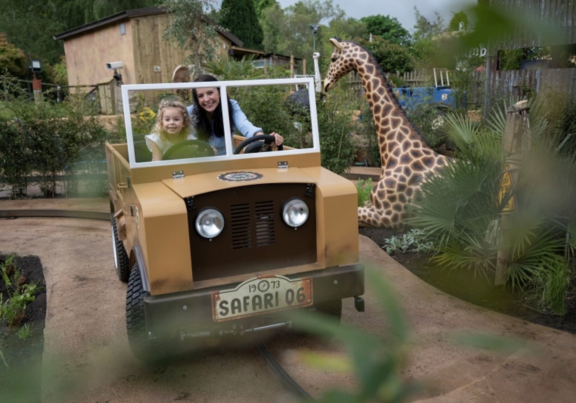 west midlands safari park employees with giraffes behind them