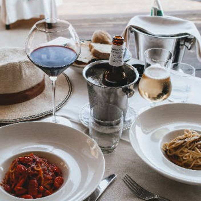 Sardinian lunch with a wine cooler, glass of wine and bowls of pasta