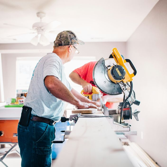 2 builders working on wood