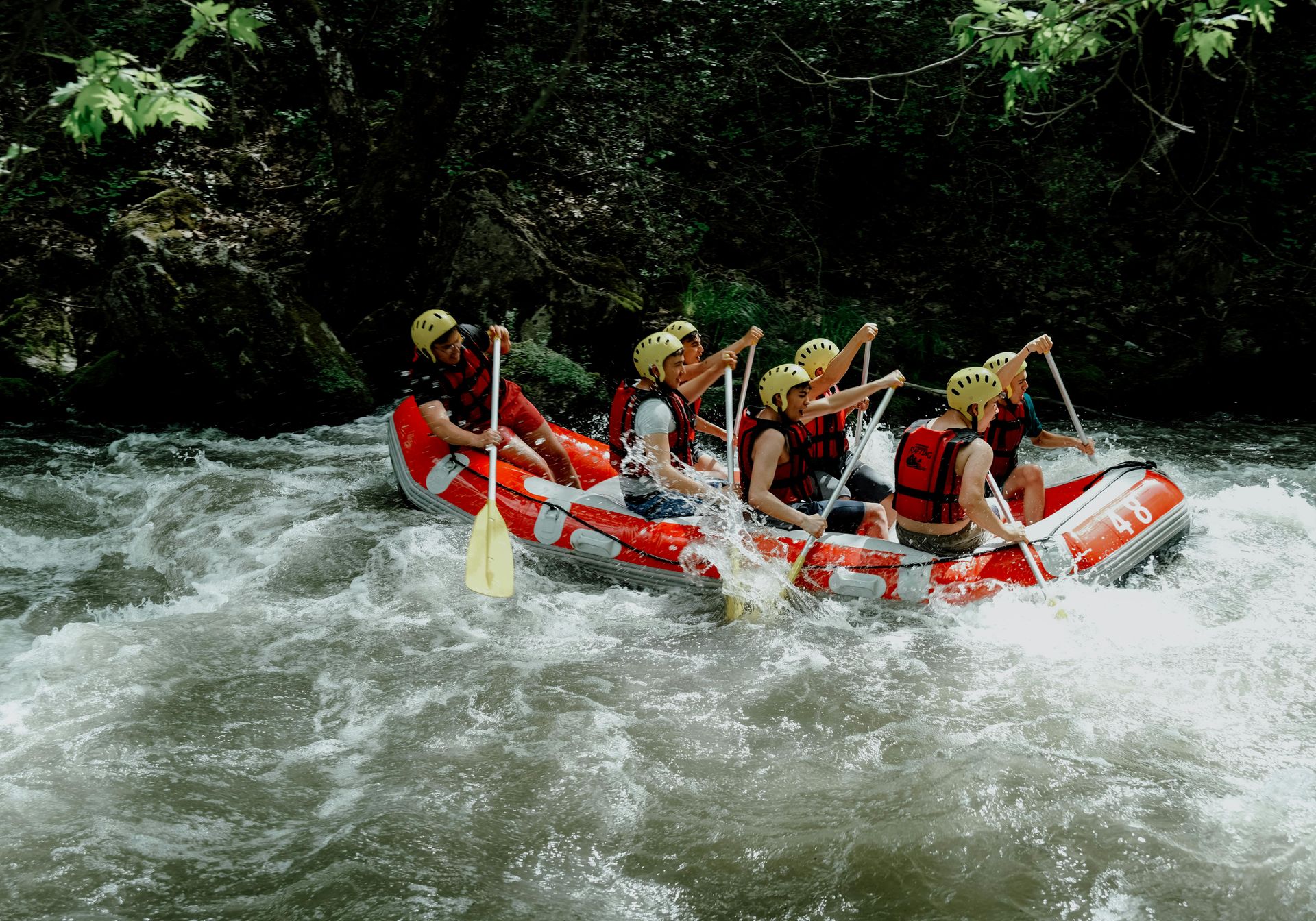 Kid jumping off rock into water in Wales