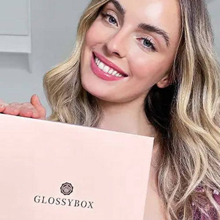 Woman holding Glossybox subscription box