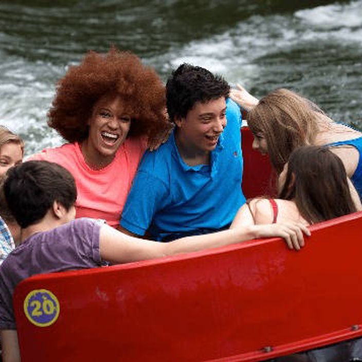 family riding a water raft ride