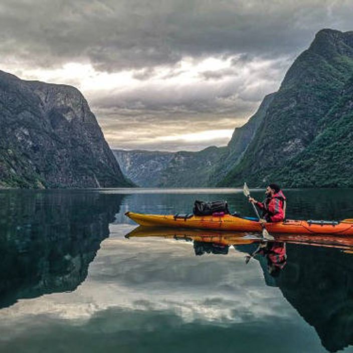 man kayaking on lake in Norway