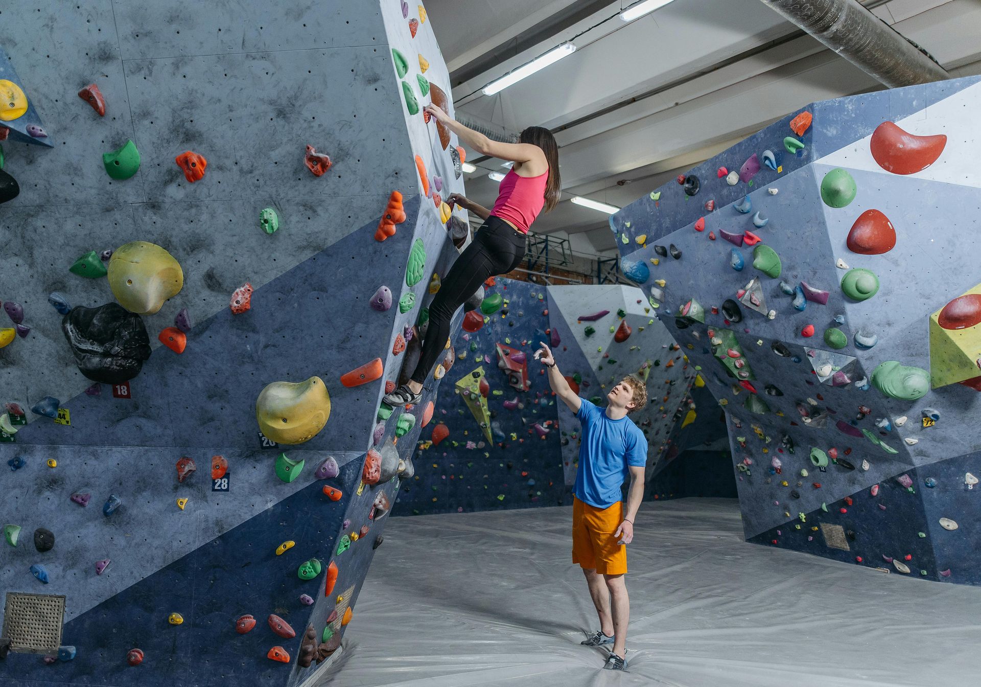Two climbers chatting in a climbing centre