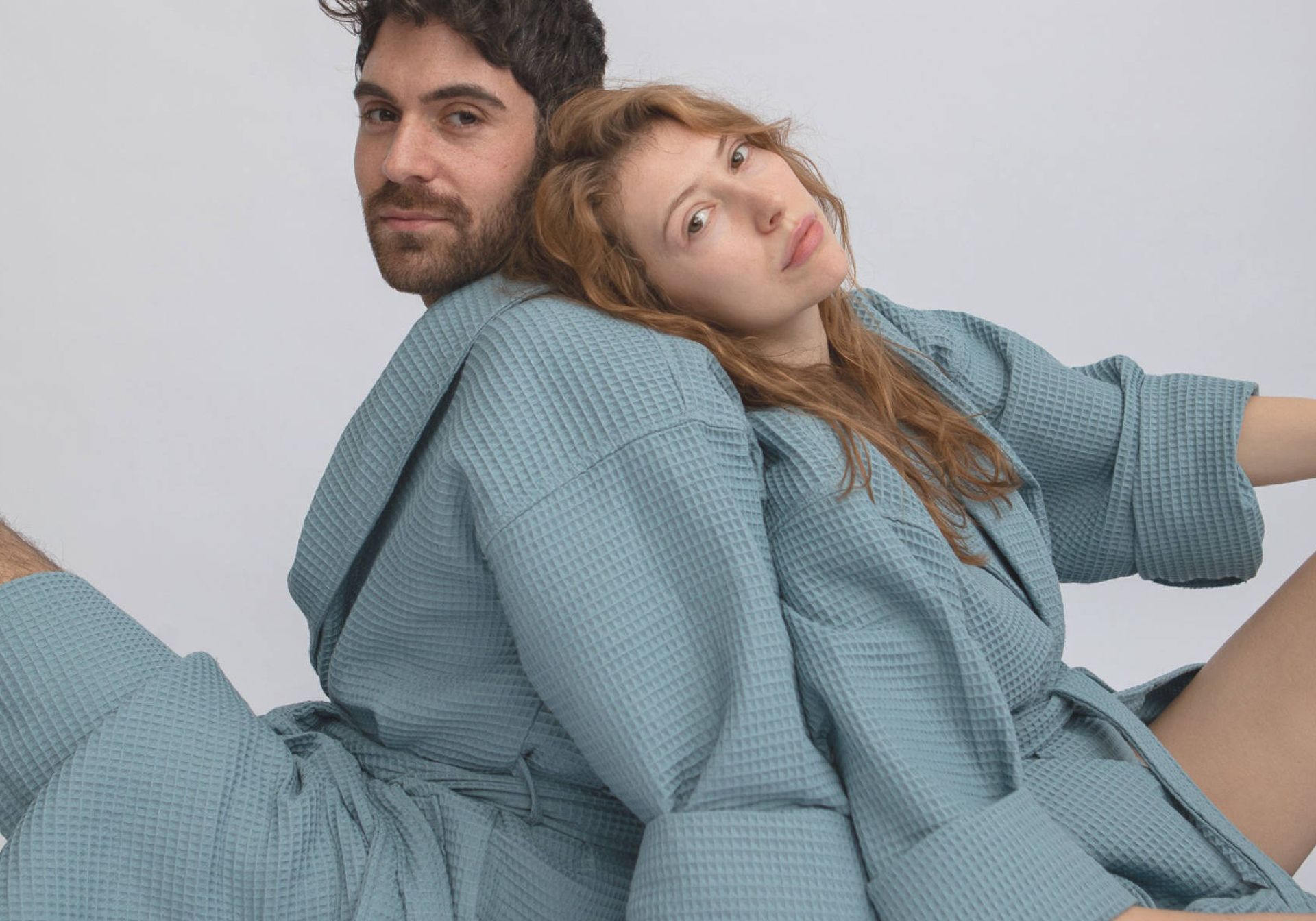 Man and woman wearing blue bathrobes