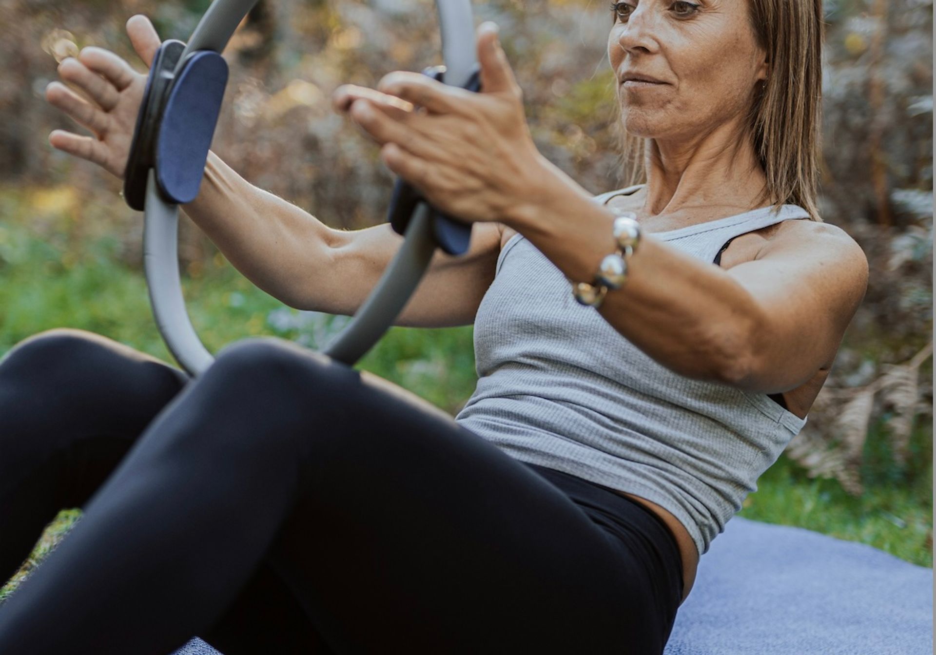Woman stretching with pilates ring