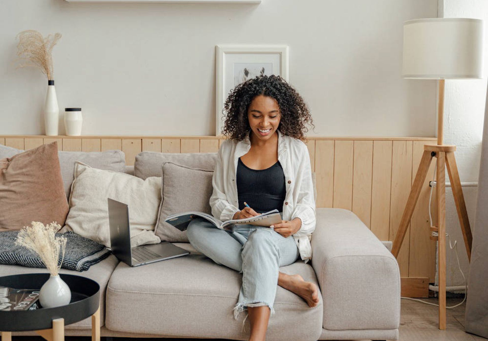 Woman sat on sofa studying or working