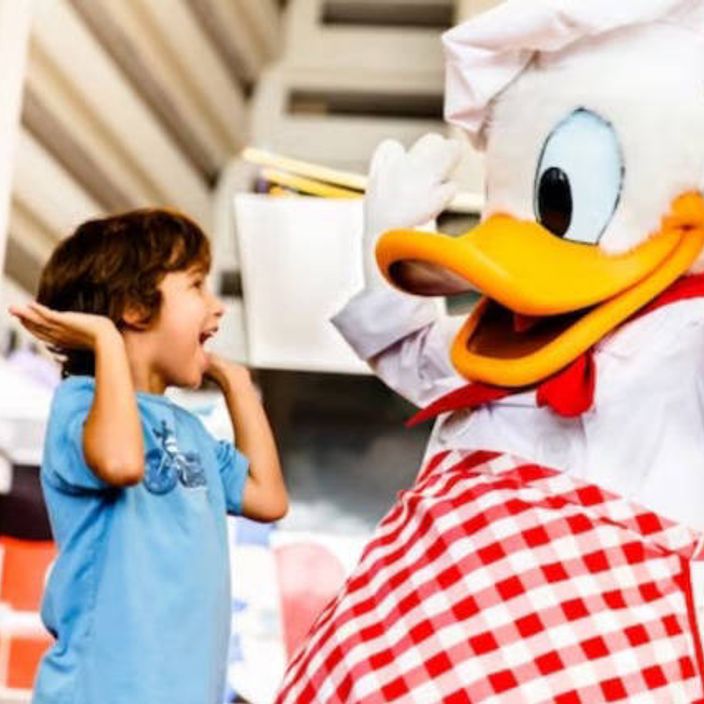 Kid high fives Daffy Duck at Disney World Florida